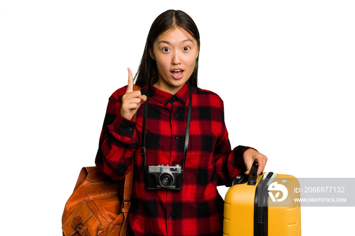 Traveler asian woman holding a suitcase isolated having some great idea, concept of creativity.