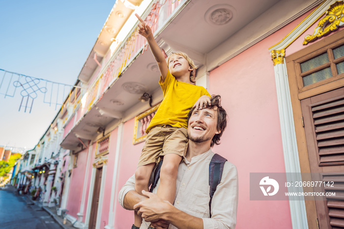 Dad and son tourists on the Street in the Portugese style Romani in Phuket Town. Also called Chinatown or the old town. Traveling with kids concept