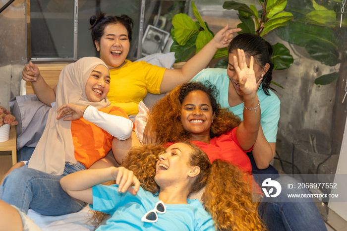 Young working women from different ethnic groups or races taking selfie while  camping on a holiday. Friendship across cultures during vacation