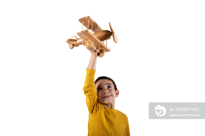 Kid plays with a wooden toy airplane. Isolated on white background