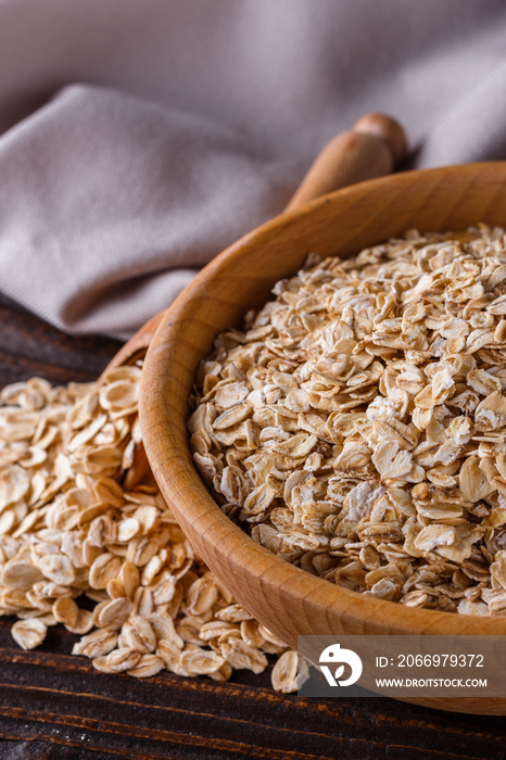 raw oatmeal on a wooden rustic background