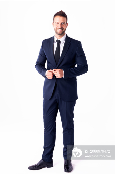 Studio shot of handsome businessman wearing suit while standing at isolated white background