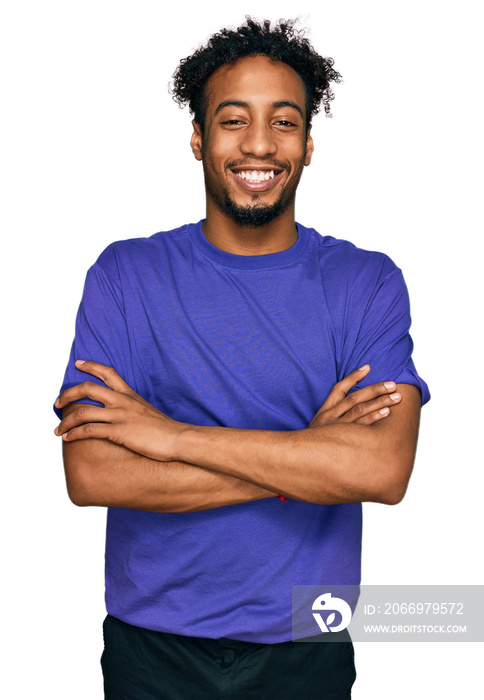 Young african american man with beard wearing casual purple t shirt happy face smiling with crossed arms looking at the camera. positive person.