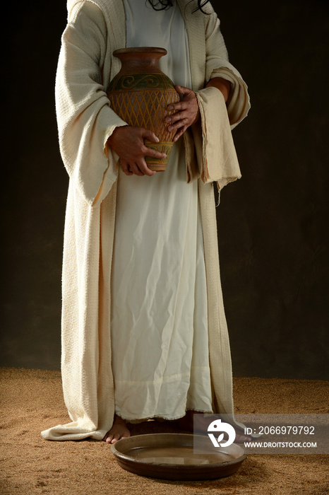 Jesus holding a jar of water standing up