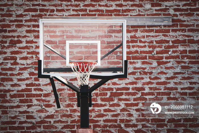 Urban basketball hoop and brick wall