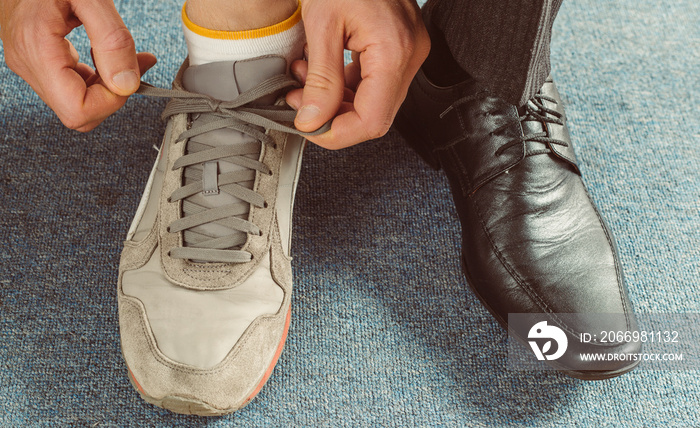 Businessman change shoes on sneakers. Healthy lifestyle balance concept.