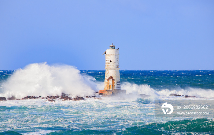 The lighthouse of the Mangiabarche shrouded by the waves of a mistral wind storm