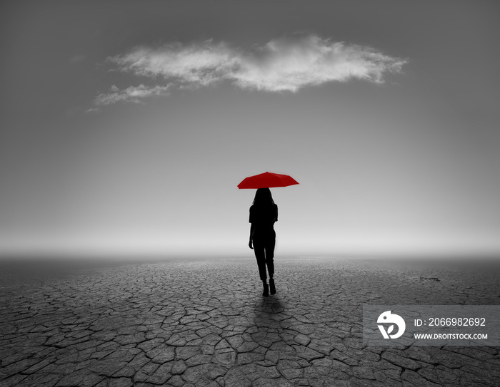 silhouette of person with red umbrella of backdrop in black and white gradation