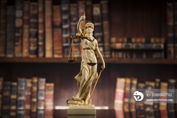 Antique statue of justice, law, books background
