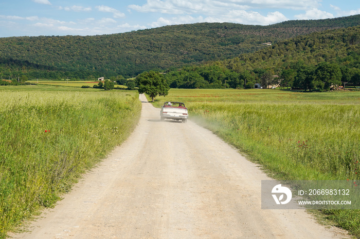 Classic vintage cabrio car on a country road