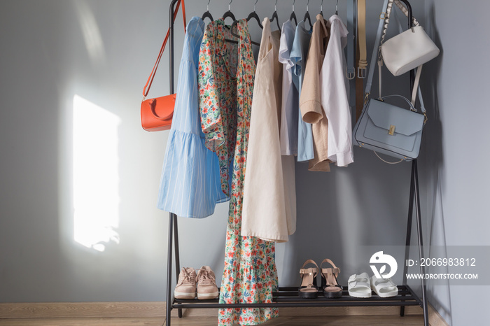 light colored womens summer clothes and shoes on  hanger