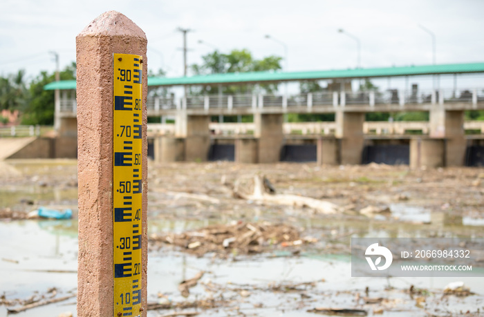 Water level gauge on the pole at the dam