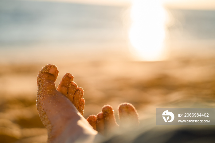 Feet in sand on the beach in Portugal