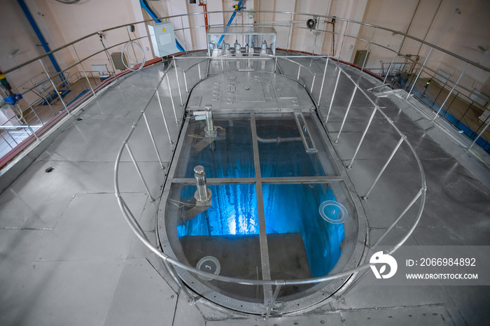 Blue glow water of nuclear reactor core powered, caused by Cherenkov radiation, fuel plates industrial uran