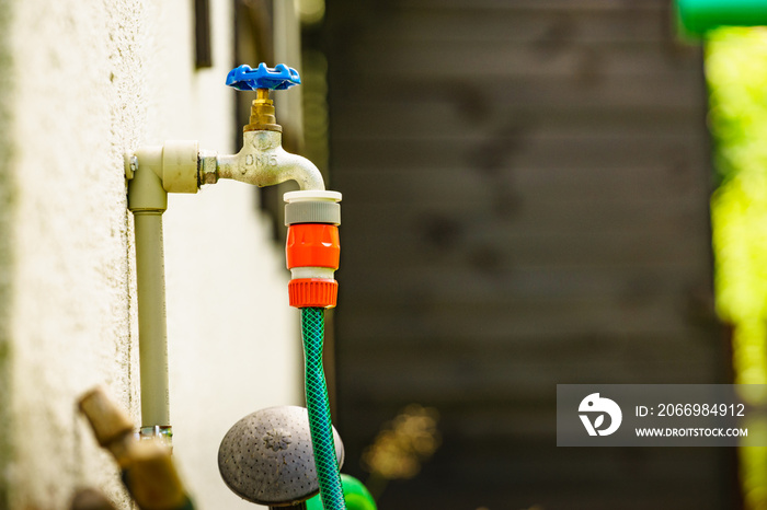 Garden tap with hosepipe attached.