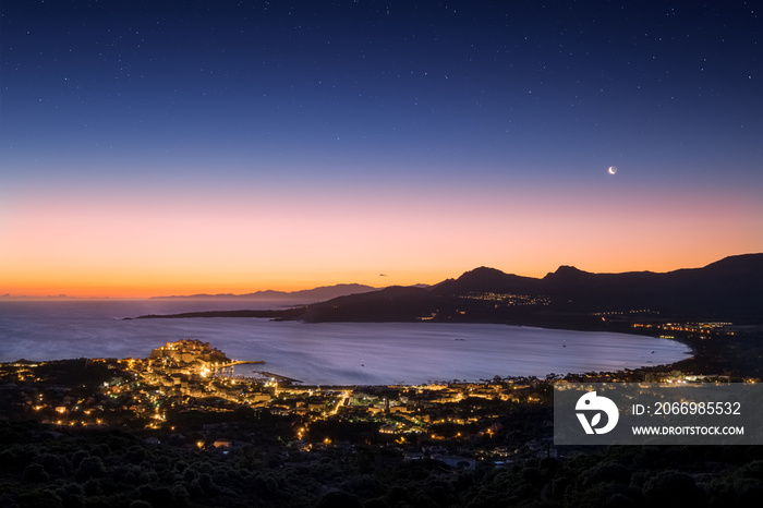 Moon rising over Calvi Bay in Corsica