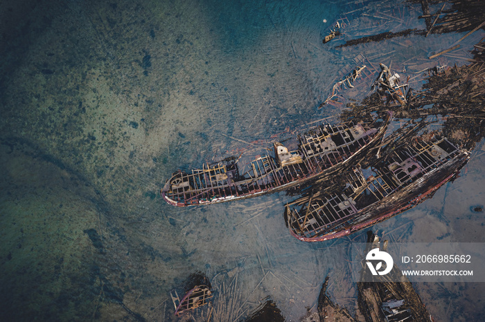 Destroyed wooden pirate ships washed up on the seashore, Aerial top view