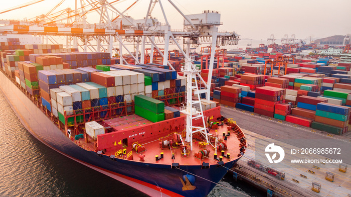 crane loanding cargo container to container ship in the international terminal yard port  concept freight shipping by ship at sunrise, the crane working in the sea  forwarder mast