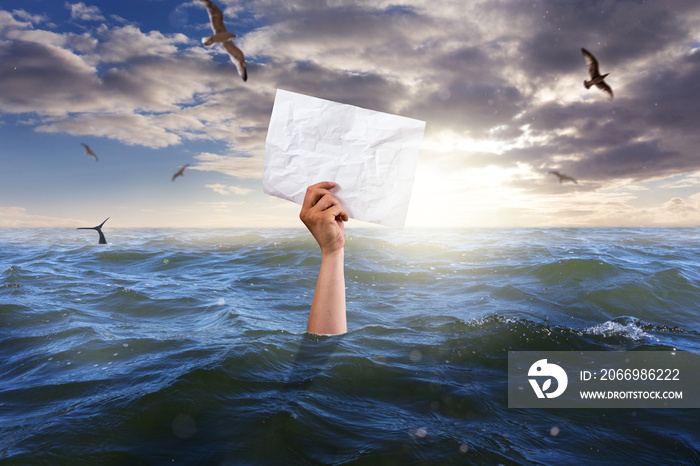 single hand of drowning man holding white empty paper