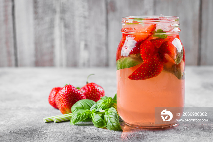 Summer Food and Drink. Mason Jar with strawberry basil lemonade on concrete table. Copy space