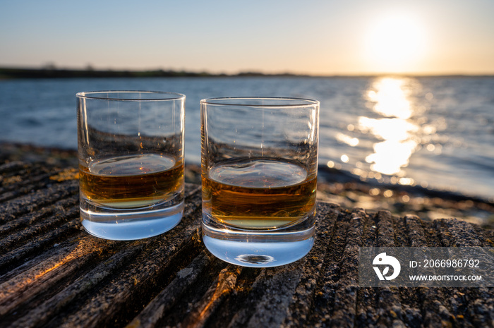 Drinking single malt Scotch whisky at sunset with sea, ocean or river view, private whisky tours in Scotland, UK