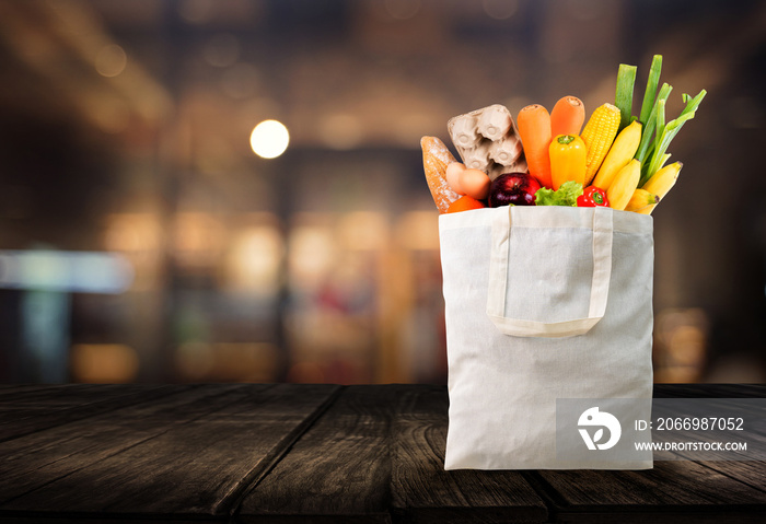 Eco day use shopping bag with vegetables grocery shopping in supermarket