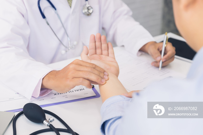 Doctor examining patient pulse by hands. Healthcare and medical service.