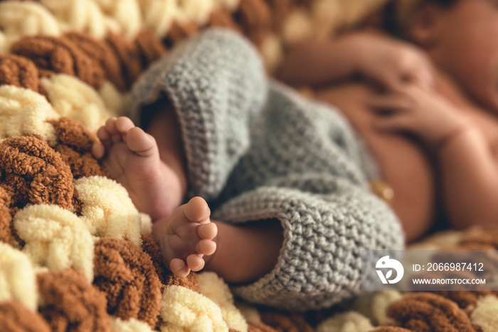 Cute shot of baby feet. Fluffy blanket underneath and wool clothes. Family moments. Baby’s first photoshoot. High quality photo