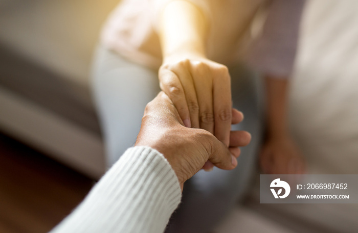 Man giving hand to depressed woman,Psychiatrist holding hands patient,Mental health care concept