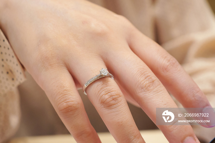 Close up diamond ring on woman finger