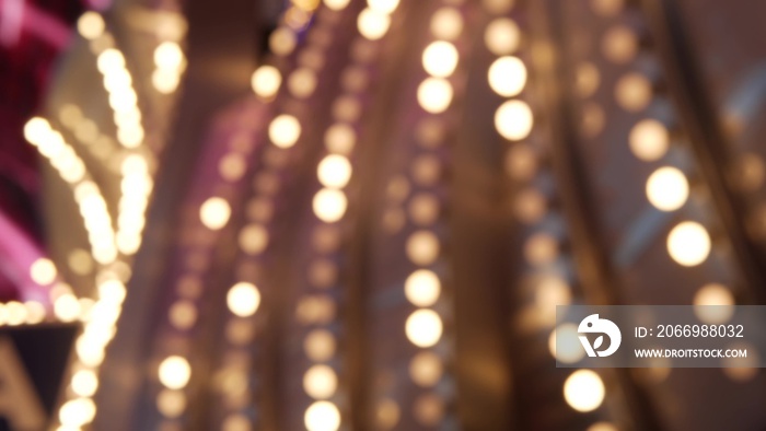 Defocused old fasioned electric lamps glowing at night. Abstract close up of blurred retro casino decoration shimmering, Las Vegas USA. Illuminated vintage style bulbs glittering on Freemont street