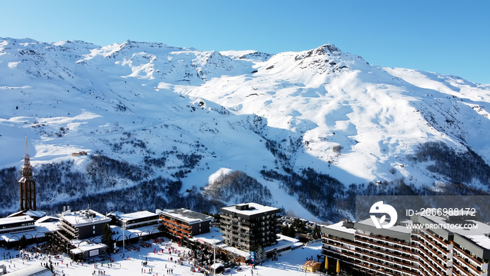 Majestic winter aerial landscape and ski resort with typical alpine wooden houses in French Alps, Les Menuires, 3 Vallees, France, Europe