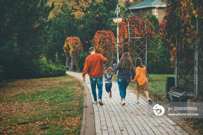 Happy family walking in autumn park