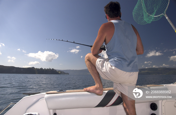 Fisherman fishing on Lake Rotoiti New Zealand