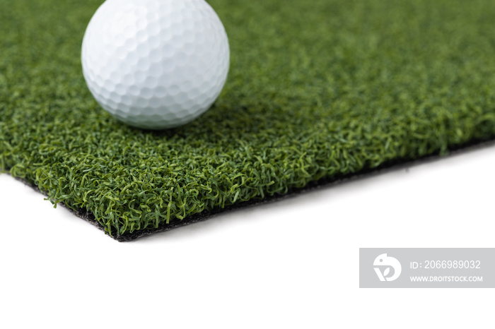 Golf Ball Resting on Section of Artificial Turf Grass On White Background