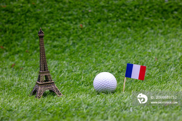 Golf ball with Flag of France and Eiffel Towel on green grass