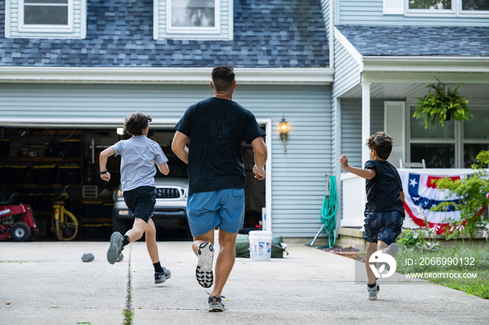 Air Force service member trains with his sons in a morning workout in preperation for a PT fitness test.