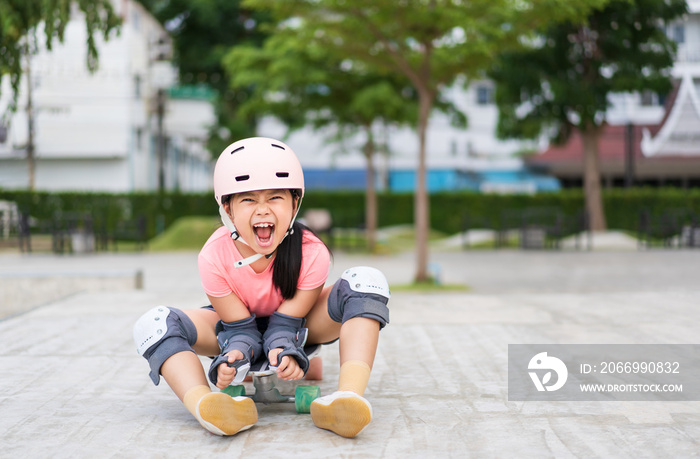 asian child skater or kid girl smile playing skateboard or sitting open mouth laugh to shout on surf skate and fun in skate park for extreme sports to wear helmet wrist knee support for body safety