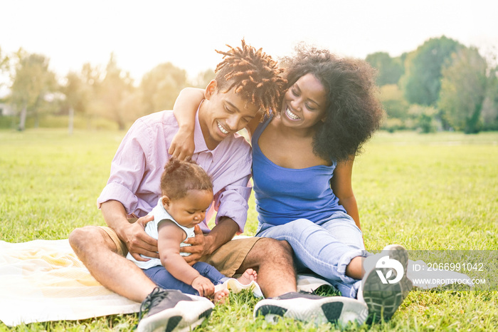 Happy black family having fun doing picnic outdoor