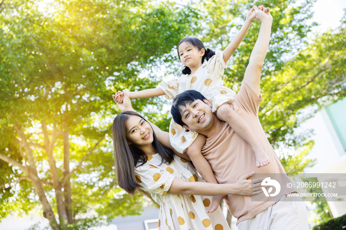 asian family Parents and daughters doing a happy walk in the village garden. During the holidays weekends to relax. friendship and living together. member health care. Concept health insurance