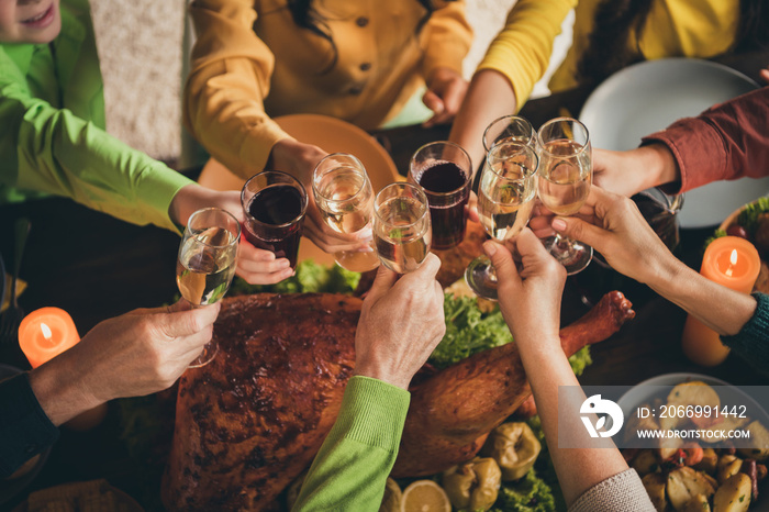 Everyone is here. Cropped photo of full family long-awaited gathering sit served dinner table hold wineglasses golden wine stewed fruits multi-generation in evening living room indoors