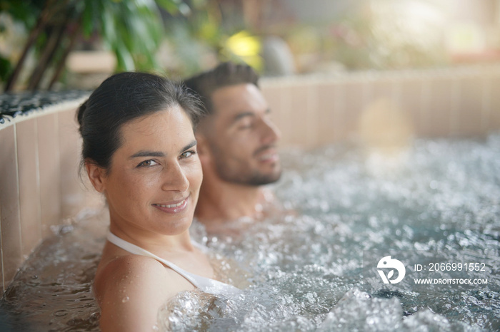 Couple relaxing in spa resort hot pool