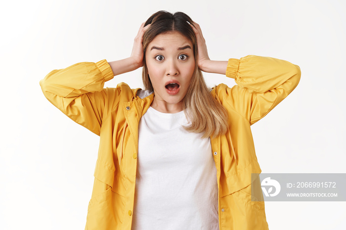 Head ging round shocking news. Concerned panicking young asian blond girl grab hair gasping drop jaw shook stare camera tensed puzzled perplexed stressful situation white background