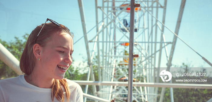 emotional girl  in the amusement park. children outdoors. vacation in the summer park banner