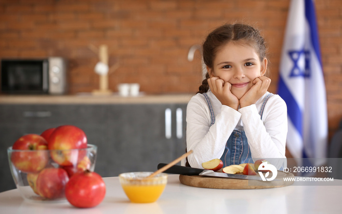 Little girl celebrating Rosh Hashanah (Jewish New Year) at home