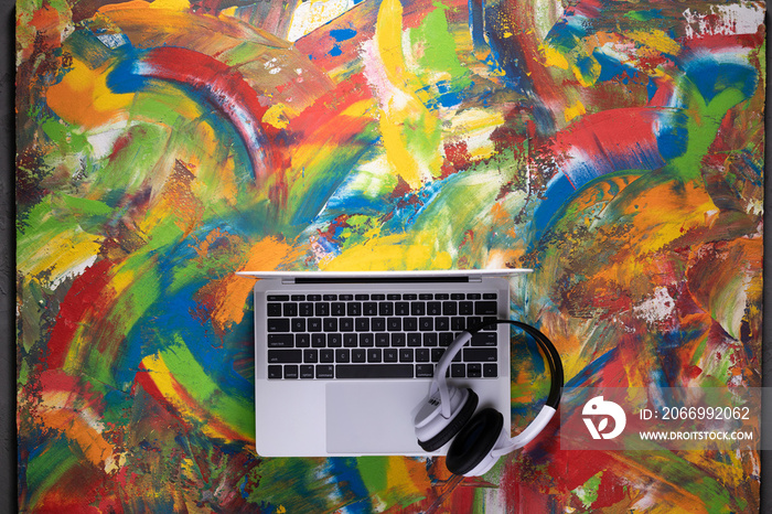 Computer laptop on abstract painting background. Construction or art design concept