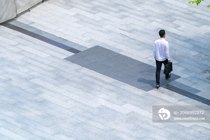 top aerial view people walk on across pedestrian at the outdoor pedestrian concrete ground.