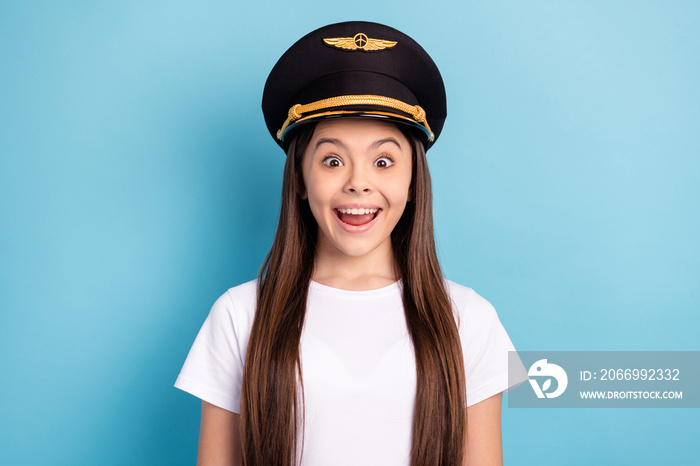 Photo of happy excited cheerful amazed little girl in pilot cap hear good mews information isolated on blue color background