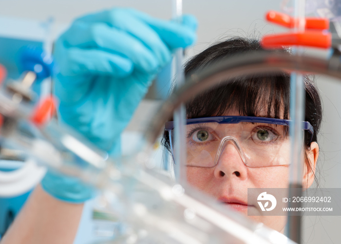 Young female chemistry tech at work