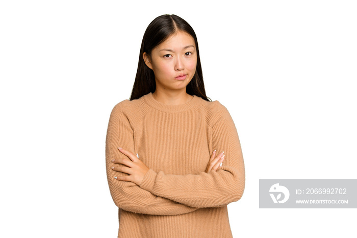 Young Asian woman isolated on green chroma background suspicious, uncertain, examining you.